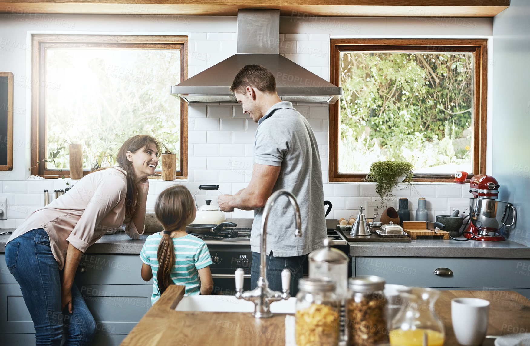 Buy stock photo Shot of a family preparing breakfast together at home