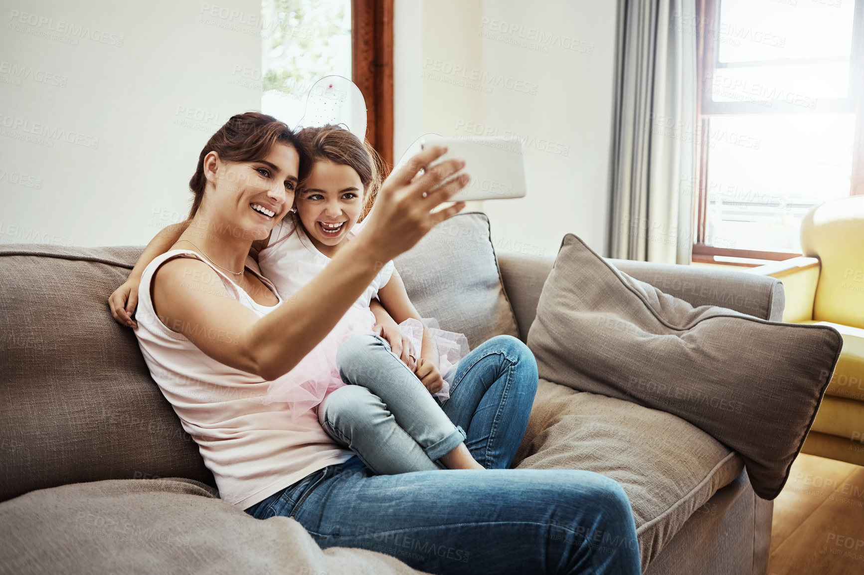 Buy stock photo Mom, girl and happy on selfie on couch for memories, fun and care with support for child development. Parent, kid and smile in living room on sofa for social media, bonding and home with butterfly