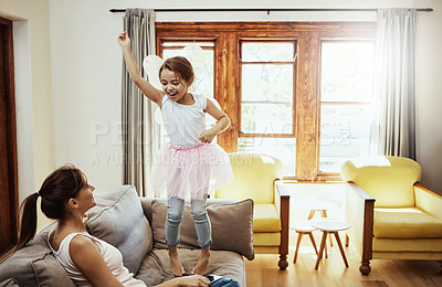 Buy stock photo Shot of a little girl having fun while bonding with her mother at home