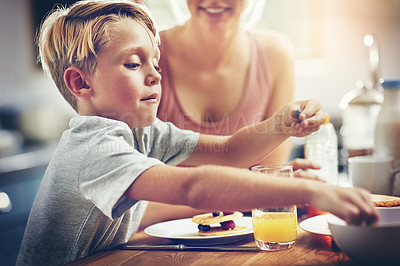 Buy stock photo Cropped shot of a little boy having breakfast at home