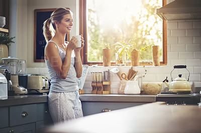 Buy stock photo Shot of a young woman having her morning coffee
