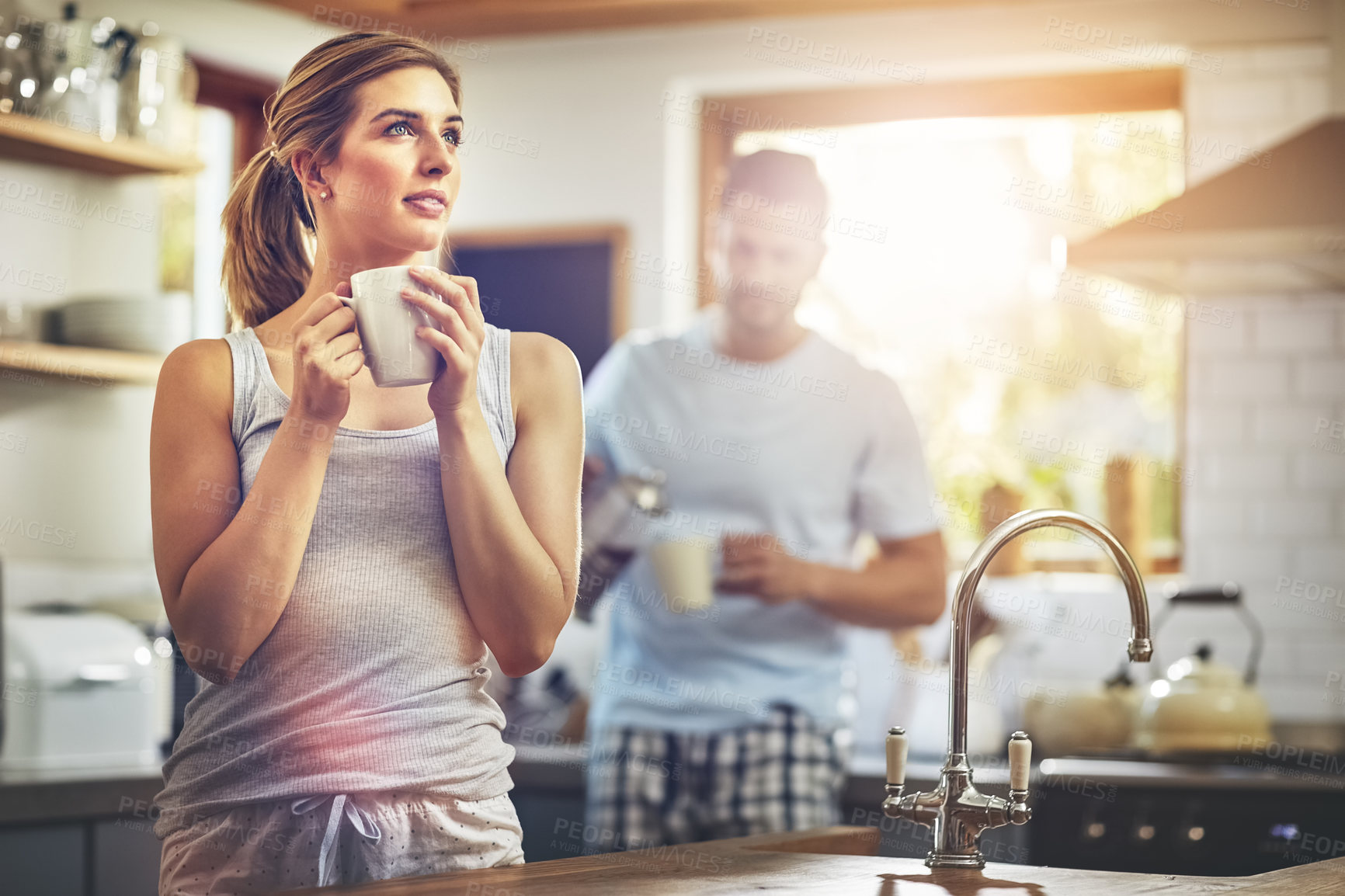 Buy stock photo Girl, happy and thinking with coffee in kitchen for daily morning routine, peace and calm for comfort. Woman, beverage and thoughts in home with man or quiet moment, contemplation and mindfulness.