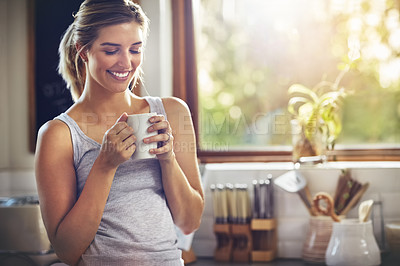 Buy stock photo Shot of a young woman having her morning coffee