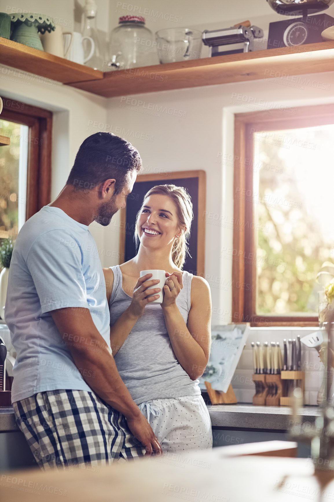 Buy stock photo Talking, happy couple and drinking coffee in home kitchen for morning conversation. Tea, man and smile of woman together for connection, love or healthy relationship for bonding with partner in house