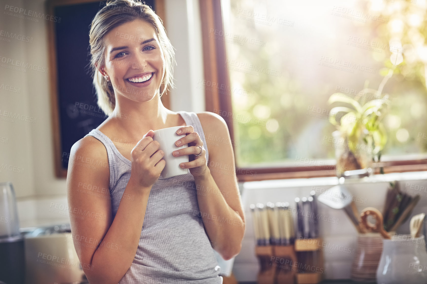 Buy stock photo Shot of a young woman having her morning coffee