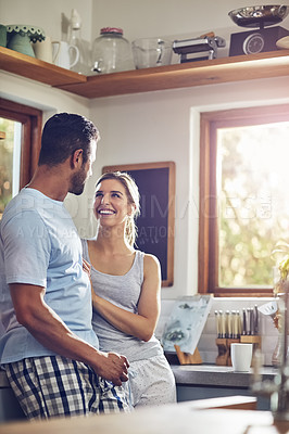 Buy stock photo Shot of a couple standing together in their kitchen