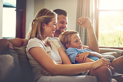 Buy stock photo Shot of a family of three spending some quality time at home