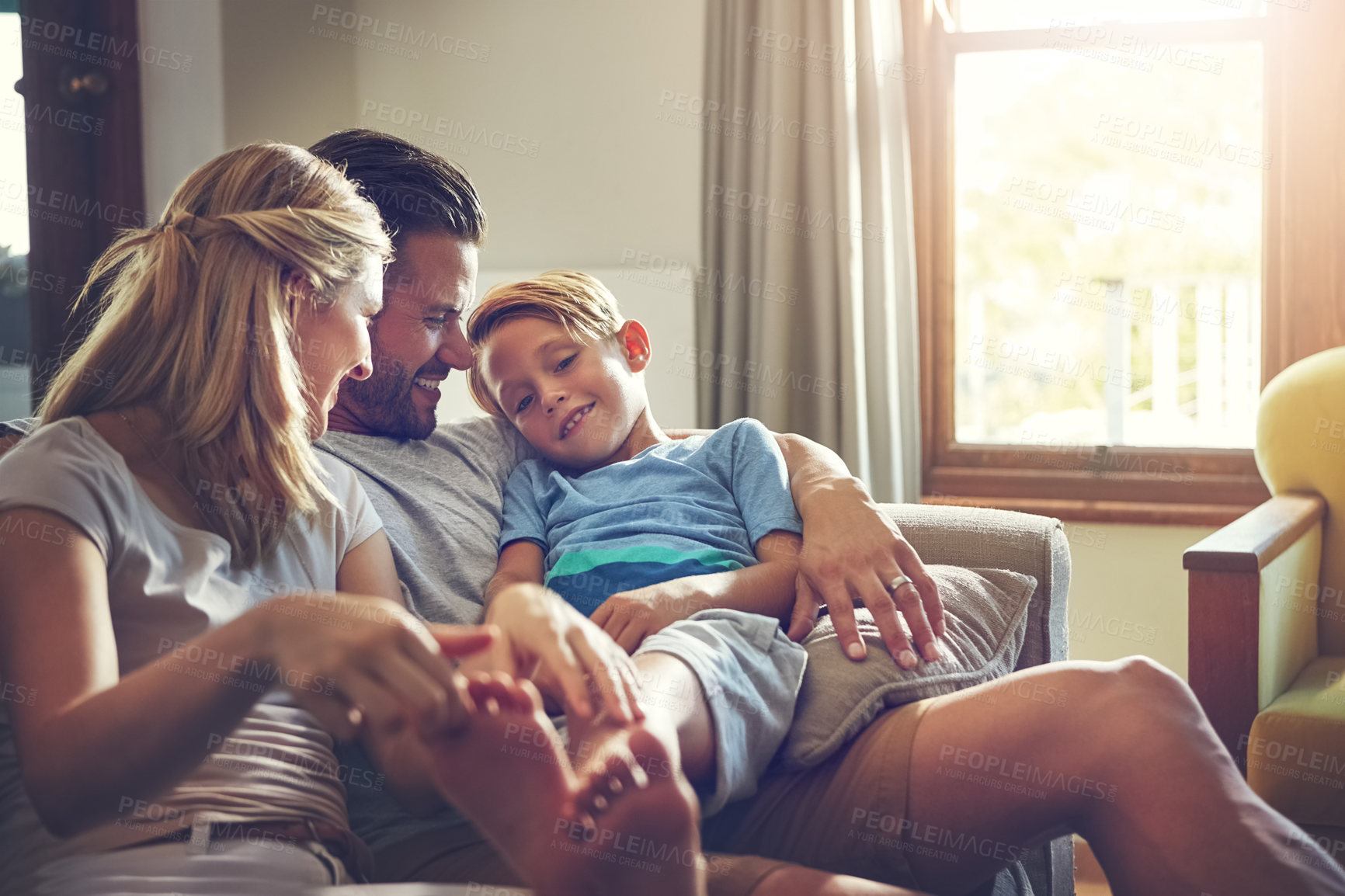 Buy stock photo Shot of a family of three spending some quality time at home