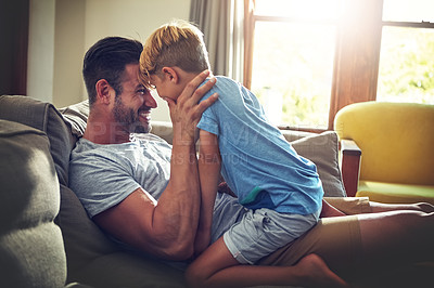 Buy stock photo Shot of a man spending some quality time with his son at home