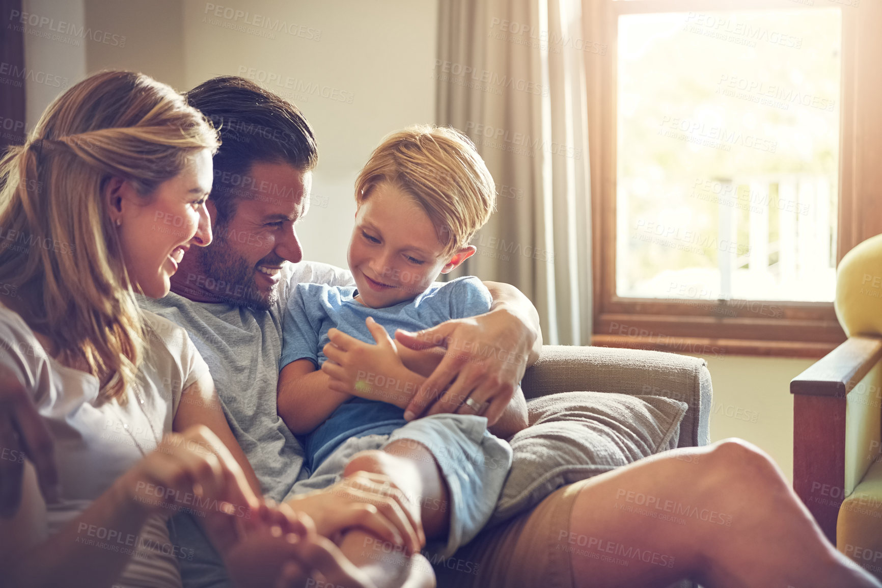 Buy stock photo Shot of a family of three spending some quality time at home