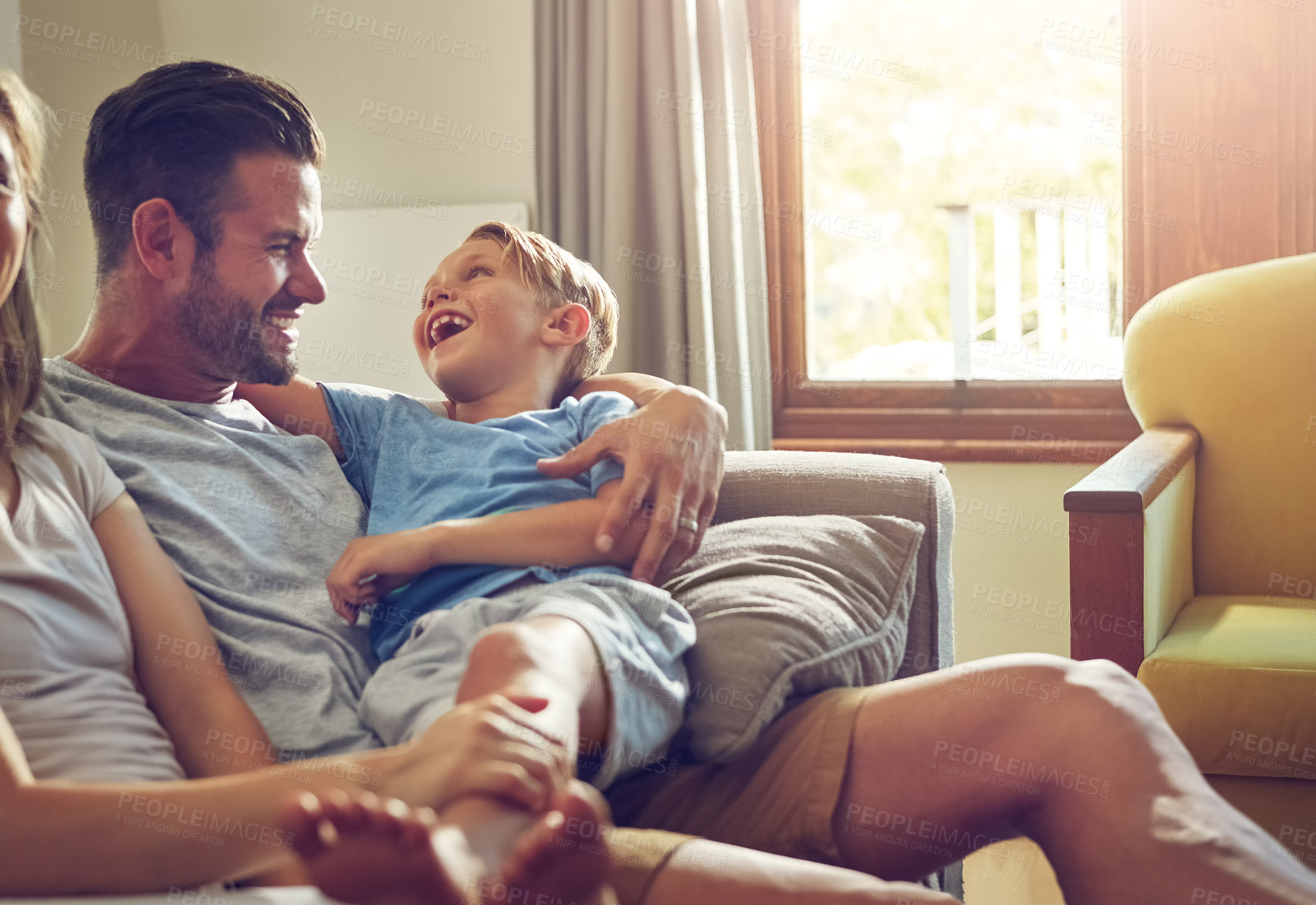 Buy stock photo Shot of a man spending some quality time with his son at home
