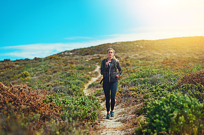 Buy stock photo Woman running through field, fitness outdoor with cardio and training for marathon with young athlete and sports. Female runner in nature, hiking trail and run for exercise, healthy and active person