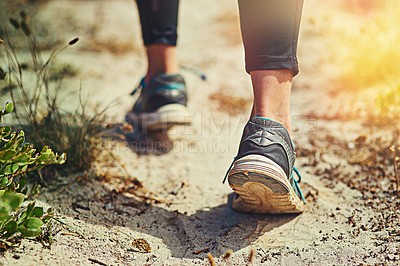 Buy stock photo Close up shot of an unrecognizable woman's sneakers outdoors