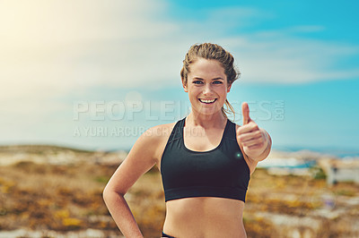 Buy stock photo Shot of a sporty young woman showing thumbs up outdoors