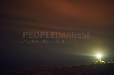Buy stock photo Shot of a lighthouse as the sun sets outdoors