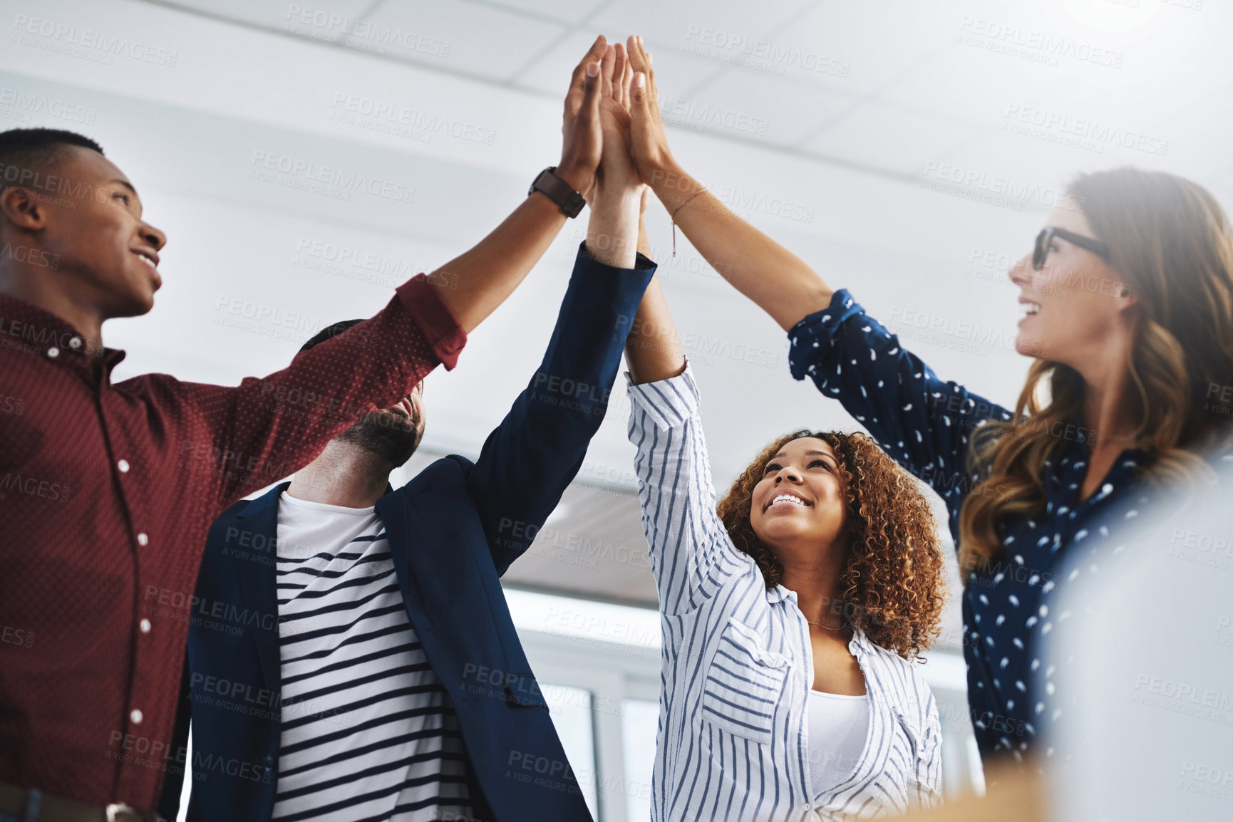 Buy stock photo Shot of creative employees celebrating in a modern office