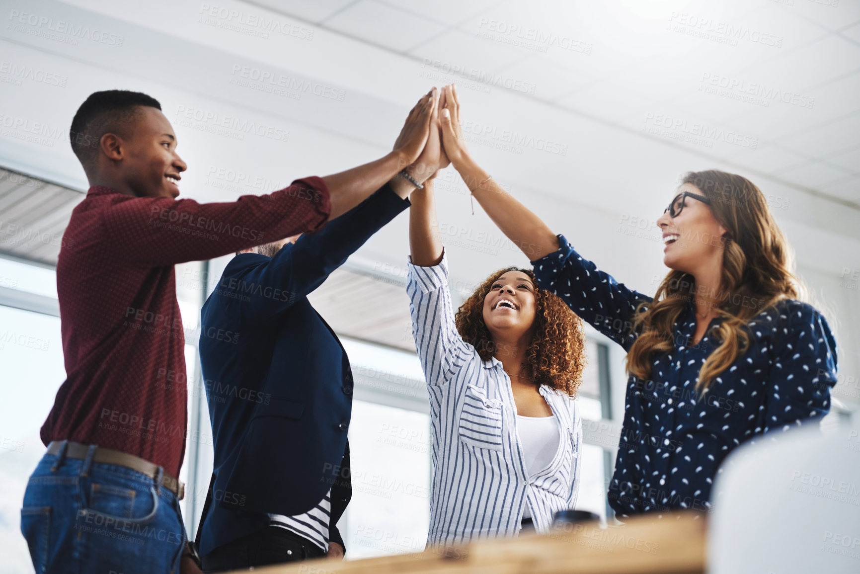 Buy stock photo Shot of creative employees celebrating in a modern office