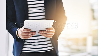 Buy stock photo Cropped shot of a businessman using a digital tablet in a modern office