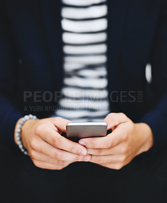 Buy stock photo Cropped shot of a businessman using a mobile phone