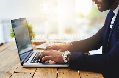 Buy stock photo Cropped shot of a businessman using a laptop at his work desk