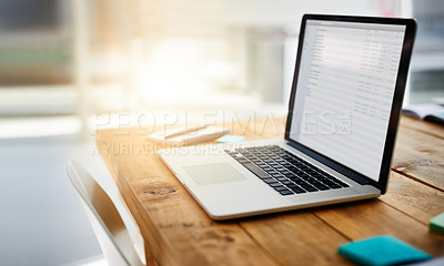 Buy stock photo Shot of a laptop on a desk in a modern office 