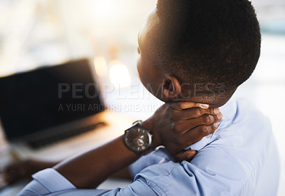 Buy stock photo Shot of a young unrecognizable businessman suffering from neck pains while trying to work in the office