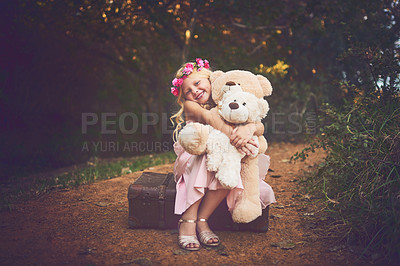 Buy stock photo Shot of a happy little girl sitting and waiting with her teddy bears in the middle of a dirt road