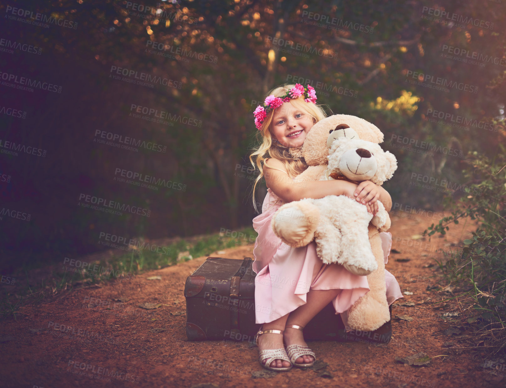 Buy stock photo Happy, teddy bear and portrait of child in nature for fantasy, imagination or play time in forest. Smile, sweet and cute girl kid from Germany with flower crown and plush toy outdoor in woods.