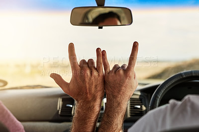 Buy stock photo Shot of two unrecognizable men putting their hands together to make a hand sign  while driving in a vehicle