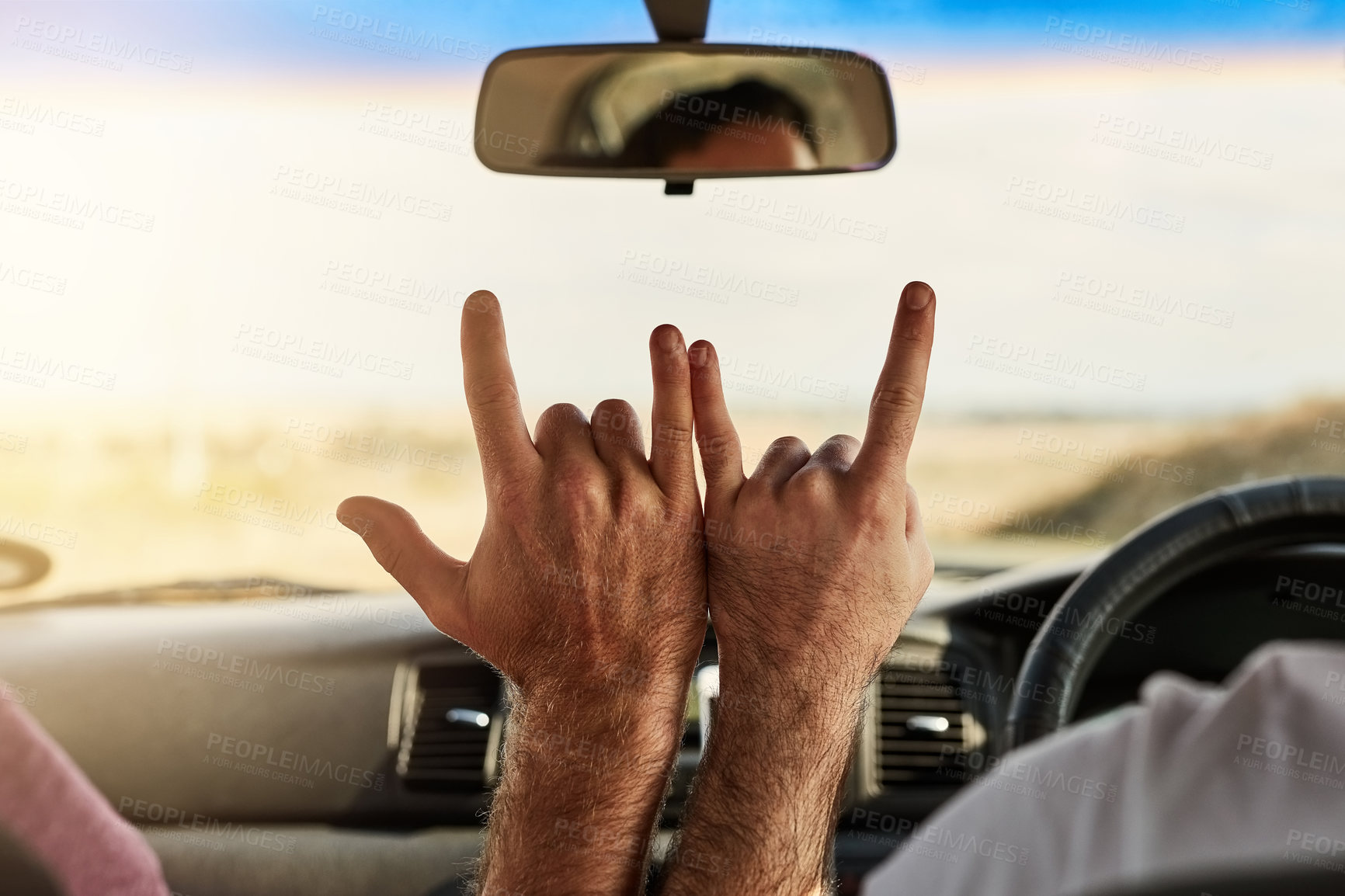 Buy stock photo Shot of two unrecognizable men putting their hands together to make a hand sign  while driving in a vehicle