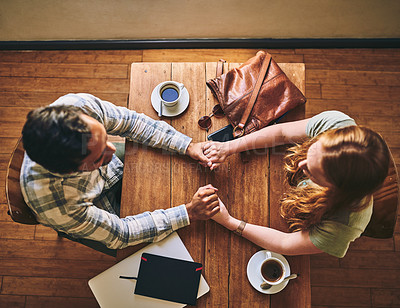 Buy stock photo Top view, couple and holding hands in cafe, celebration and relax together, Valentines day and romance. Romantic, man and woman with love, coffee shop and talking for relationship, loving and bonding