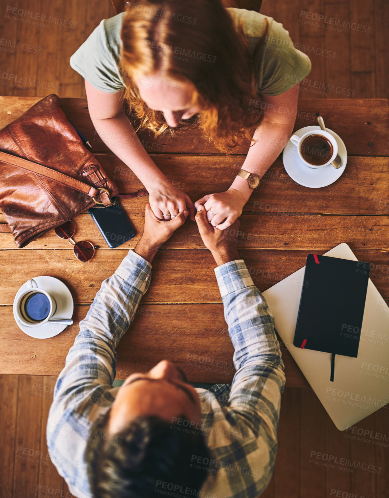 Buy stock photo Couple holding hands, love and date at coffee shop on Valentines day, trust and care, wood table top view.
People in cafe, support and respect with commitment 
 and together in relationship