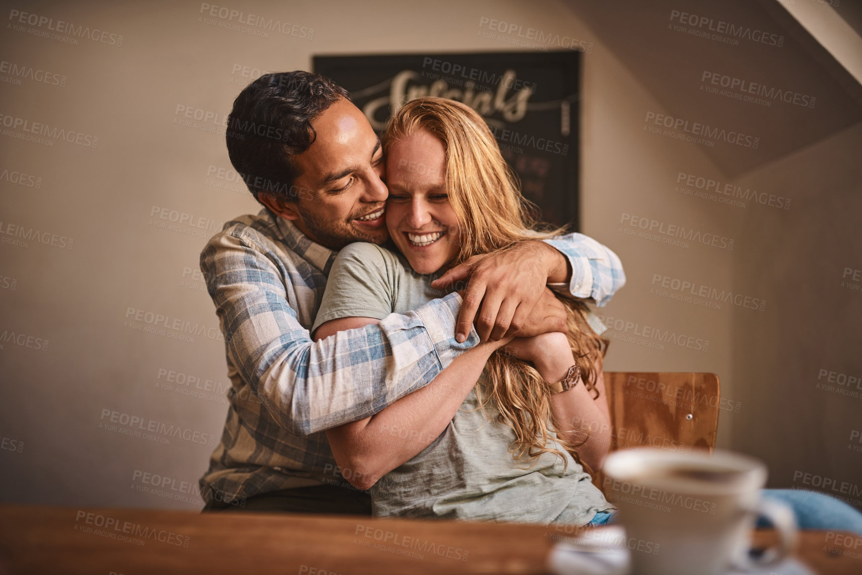 Buy stock photo Love, couple and quality time at a cafe, hug and happiness together, romance and celebrate achievement. Valentines day, man and woman with smile, romantic and in coffee shop for break, relax or happy