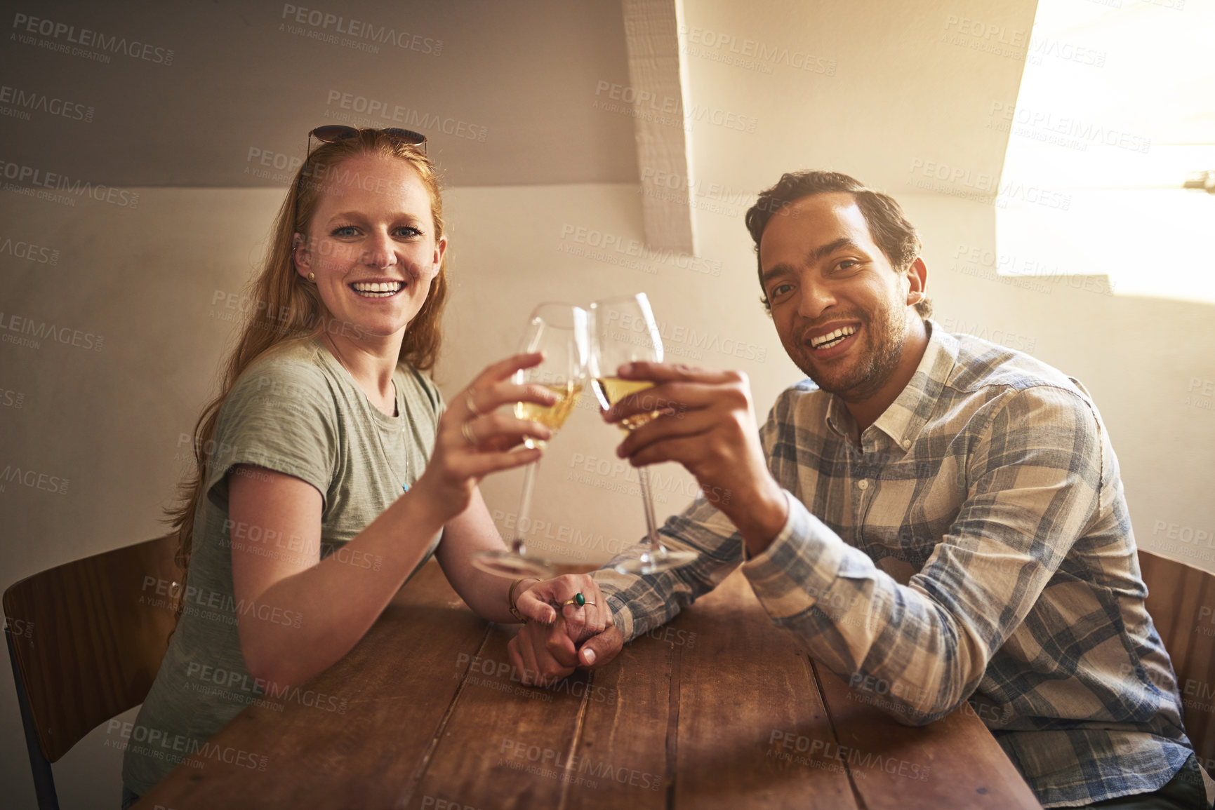 Buy stock photo Shot of a young couple spending time together at a cafe