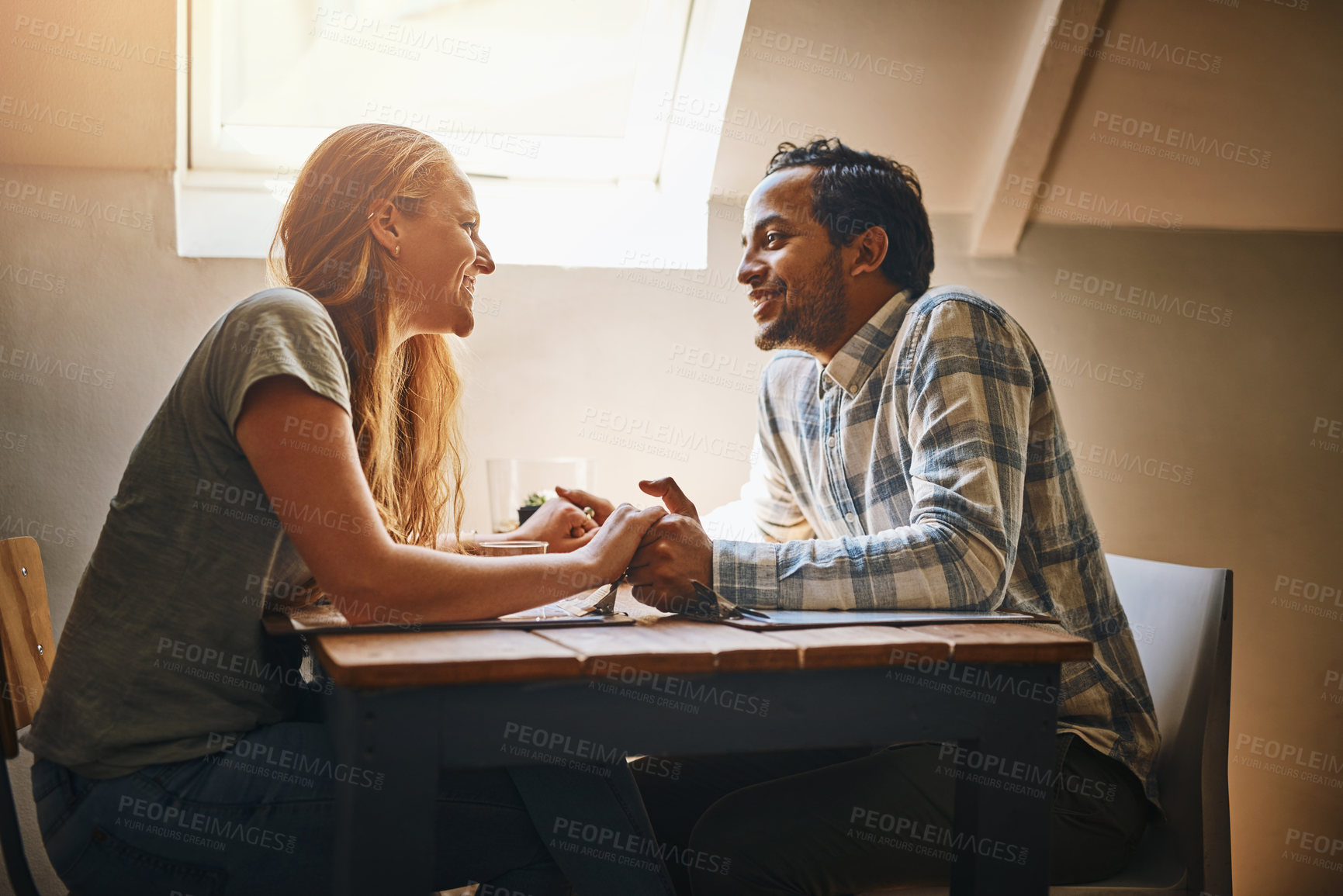 Buy stock photo Couple, love and holding hands at restaurant table, talking and bonding together. Valentines day, romance diversity and affection of man and woman on date, having fun or enjoying quality time at cafe