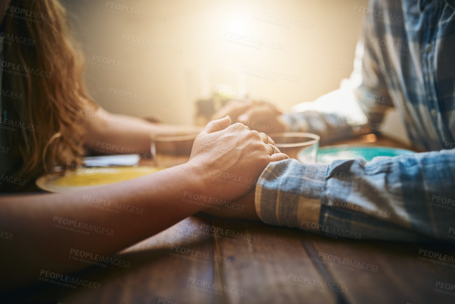 Buy stock photo Couple, love and holding hands at home on table, talking and bonding together. Valentines day, romance and affection of man and woman on romantic date, having fun and enjoying quality time in house.