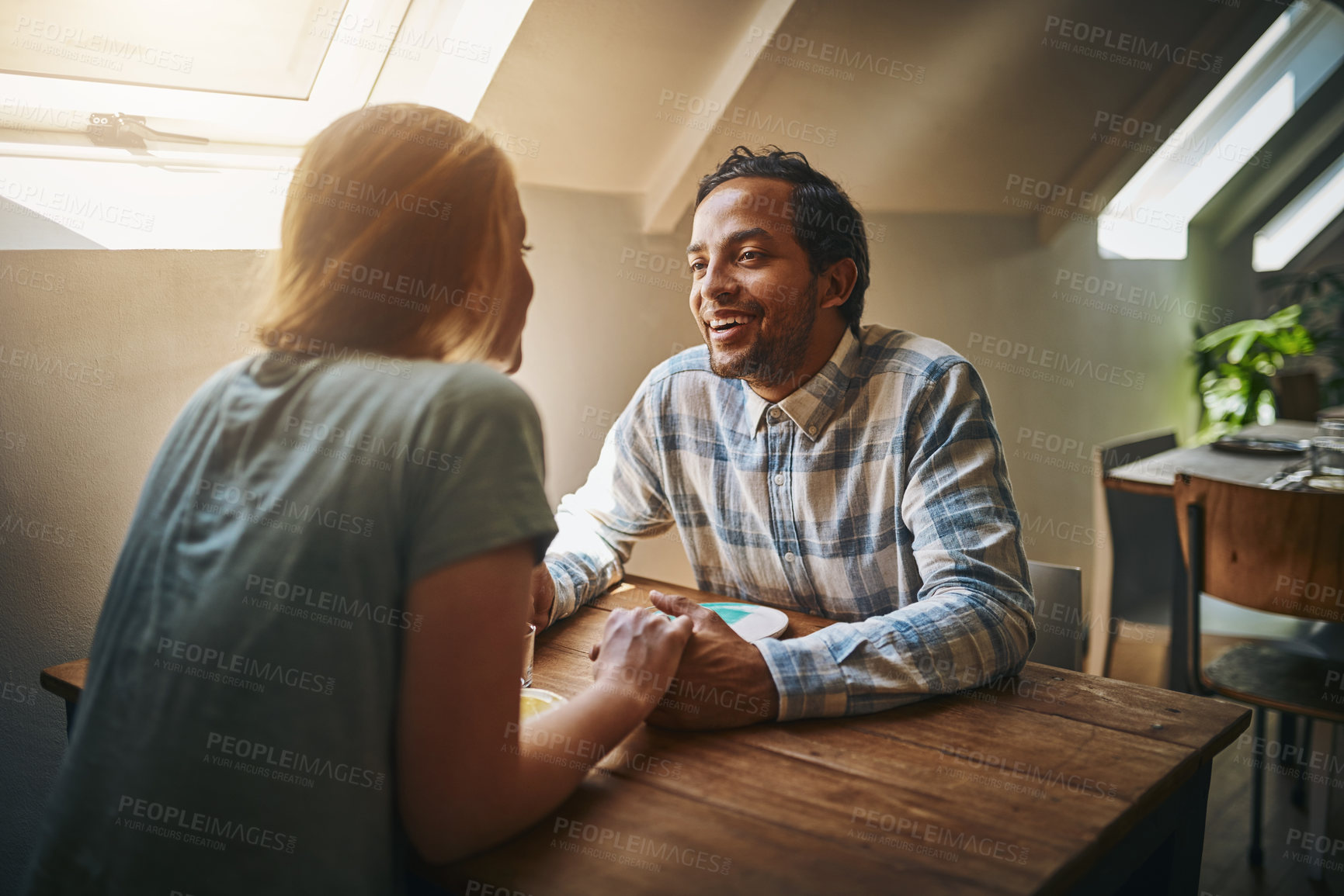 Buy stock photo Valentines, couple love and holding hands at restaurant on table, talking and laughing at joke. Comic, romance diversity and affection of man and woman on date, having fun and enjoying time at cafe