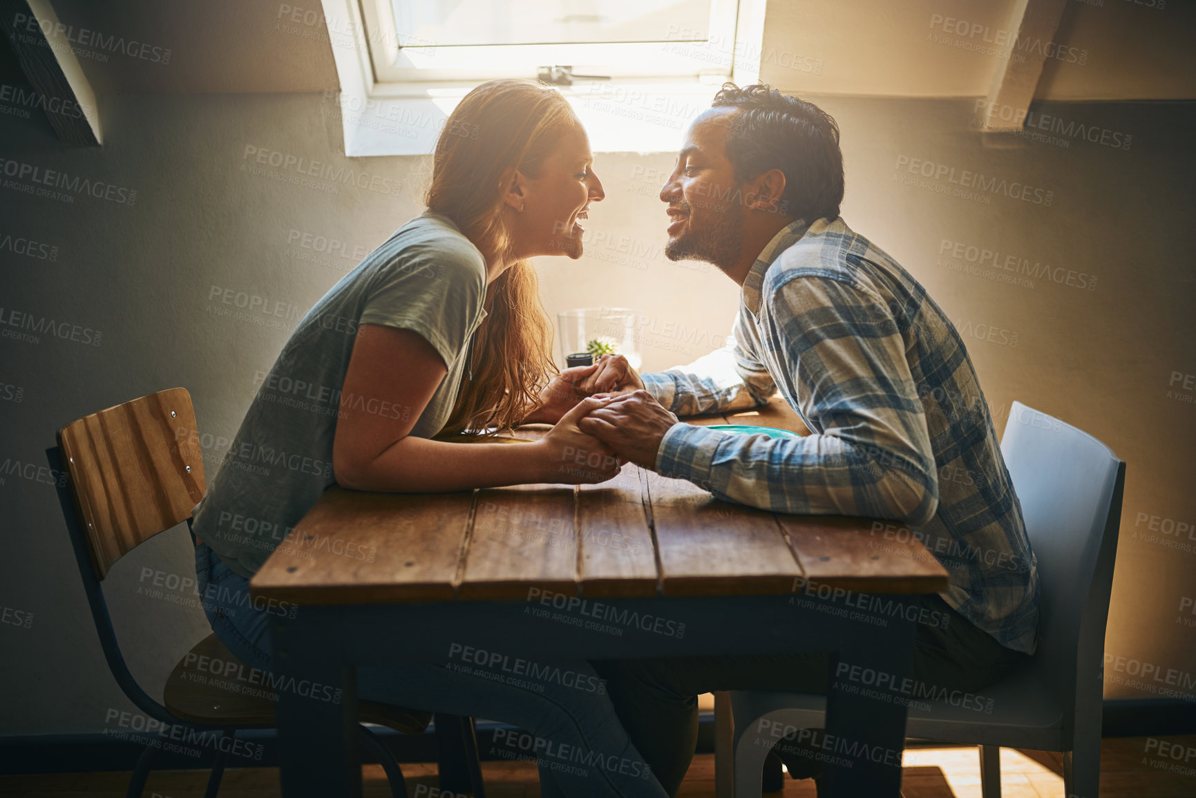 Buy stock photo Shot of a young couple spending time together at a cafe