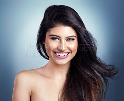 Buy stock photo Portrait, hair care and woman with smile, glow and shine on blue studio background. Face, person and model with grooming routine, salon treatment and keratin with shampoo, beauty and dermatology