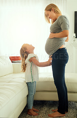 Buy stock photo Shot of a pregnant woman spending time with her little girl
