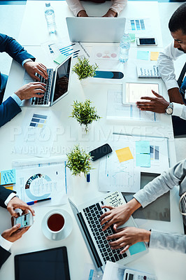 Buy stock photo High angle shot of unrecognisable businesspeople working in an office