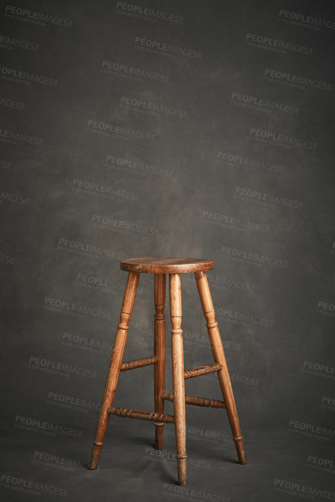 Buy stock photo Studio shot of a wooden stool against a gray background