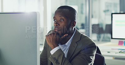 Buy stock photo Cropped shot of a handsome young businessman working on his computer in the office