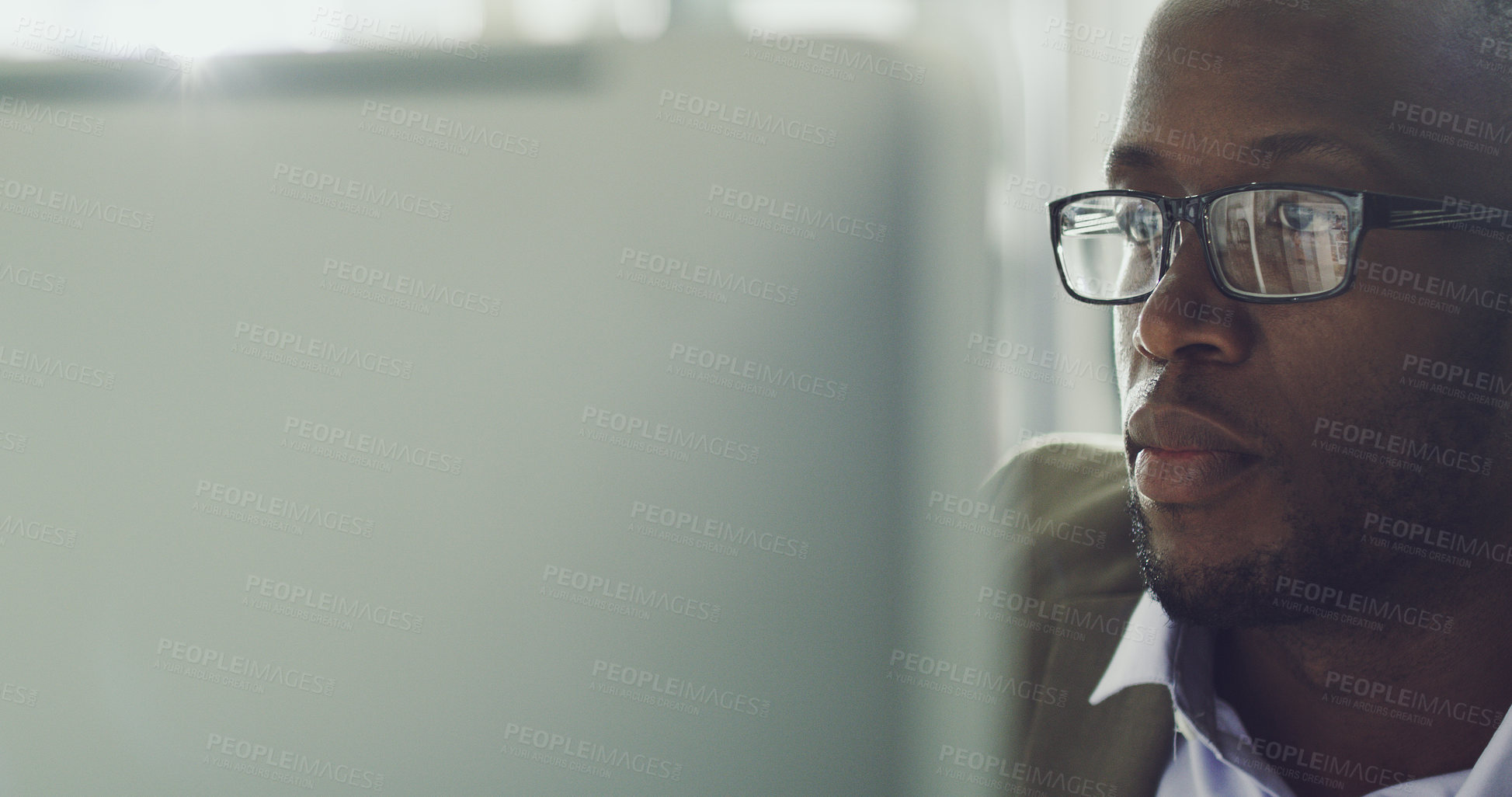 Buy stock photo Cropped shot of a handsome young businessman working on his computer in the office