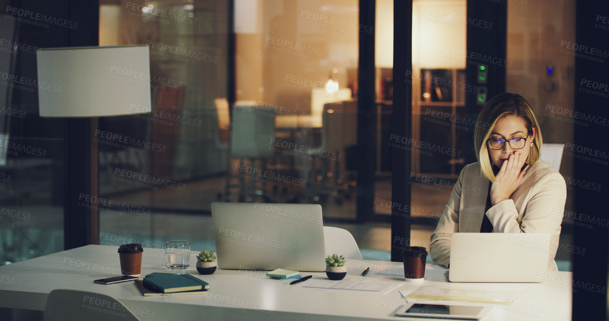 Buy stock photo Cropped shot of a businesswoman looking stressed while working in her office