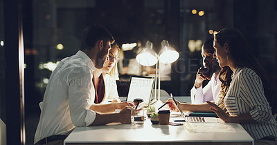Buy stock photo Cropped shot of a group of businesspeople working around a table in the office