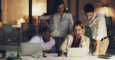 Buy stock photo Cropped shot of a group of businesspeople gathered around a laptop in their office