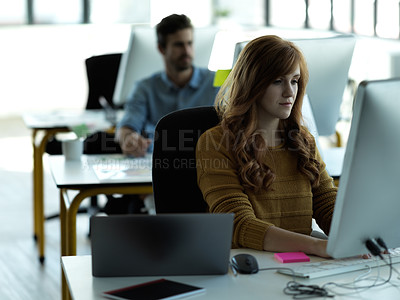 Buy stock photo Serious, computer and typing with business woman in office for web design, focus and research. Vision, technology and internet with employee in digital agency for idea, startup and email