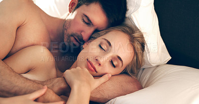 Buy stock photo High angle shot of an affectionate young couple sleeping in bed together