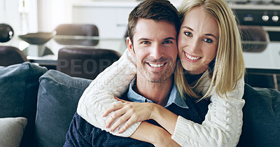 Buy stock photo Cropped portrait of an affectionate young couple sitting on their sofa at home